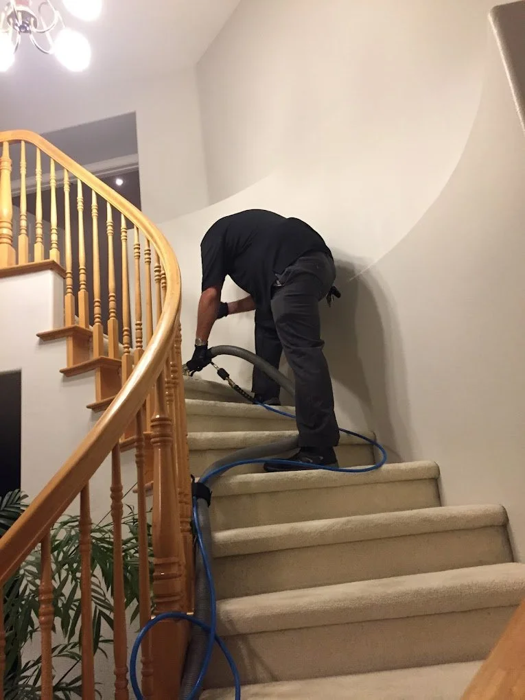 Cucamonga Carpet Cleaning technician cleaning a curved staircase carpet